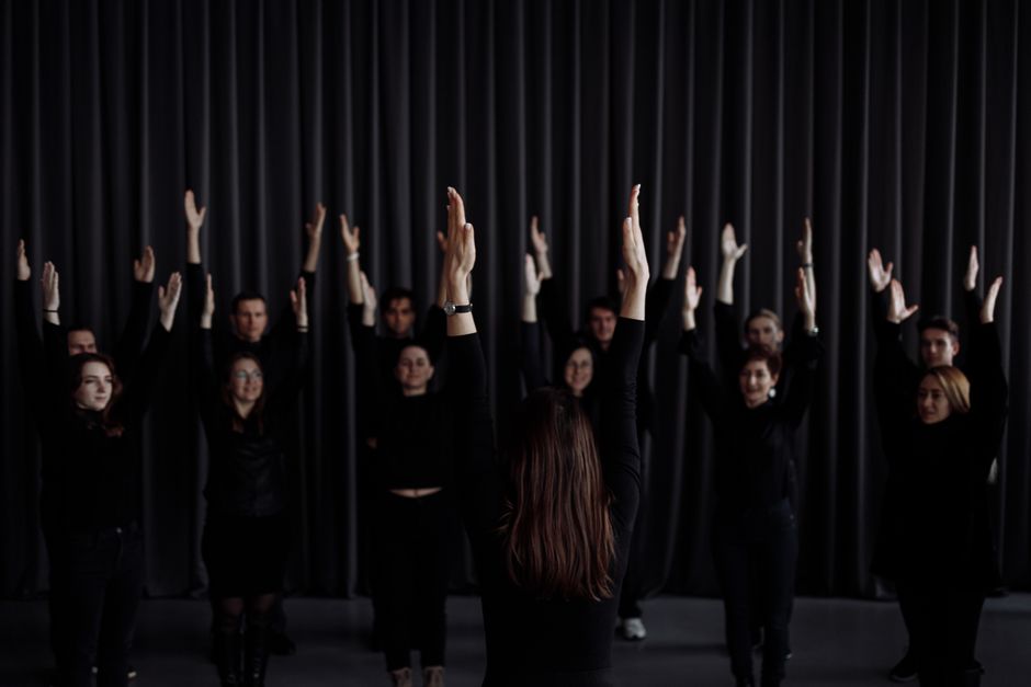Group performers rehearsing contemporary dance indoors